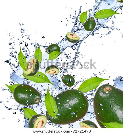 Avocado pieces falling in water splash, isolated on white background
