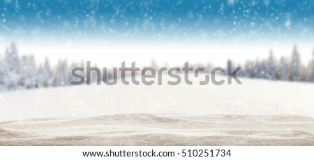 Pile of snow with blur winter panorama. Landscape with spruce trees, blue sky with sun light on background. Panoramatic view