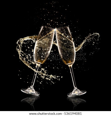 Two glasses of champagne with splash over black background. Celebration concept, free space for text