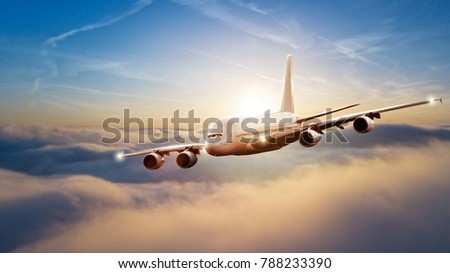 Huge commercial airplane flying above clouds in beautiful sunset light. Travel and business concept
