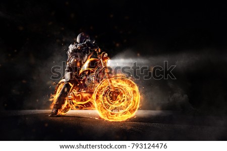 Dark motorbiker staying on burning motorcycle, separated on black background. Dark art wallpaper photo of chopper motorbike. Very high resolution image