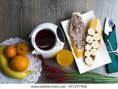 toast, chocolate spread with bread, tea, orange juice, fruit. healthy food, tasty concept. selective focus, toned image