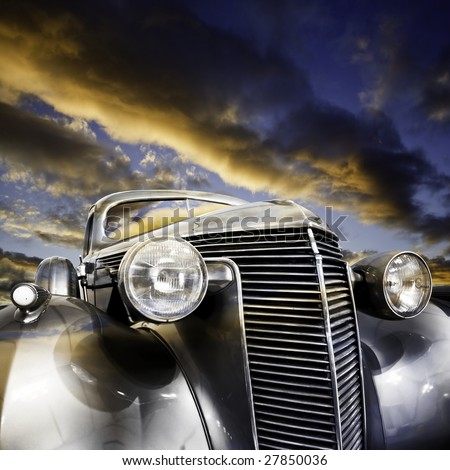 stock photo Vintage car against colorful sunset