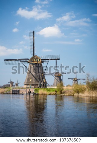 Five windmills in Holland Holland field by water