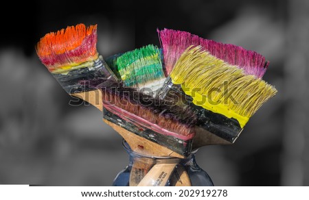 Colorful paint brushes full of paint