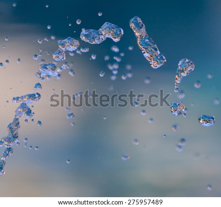 Blue water splashing in front of blue and white background