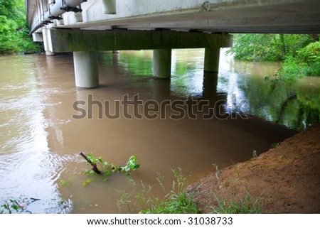 Bridge remains dry as flooded river rises