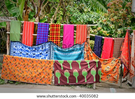 Colorful Masai Mara cloths and blanket hang in roadside stand in Tanzania, Africa
