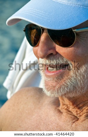 Senior Citizen suns himself at the beach