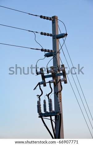Power or telephone pole with wires, cords and cables in morning light