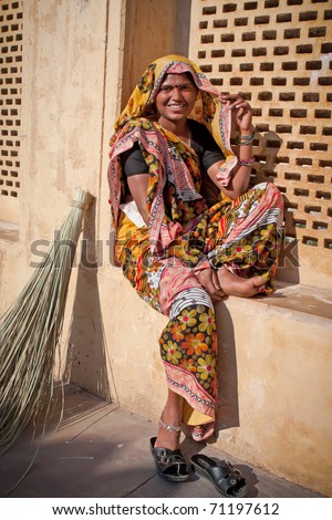 Local India woman rests before sweeping-