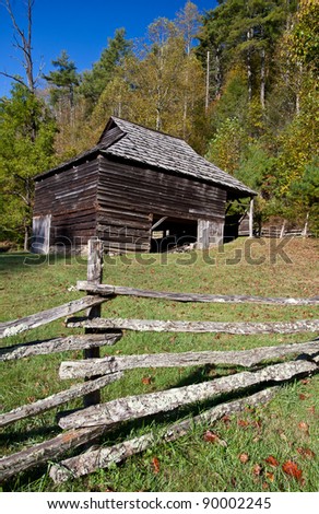 Antique barn made of wood surrounded by fence