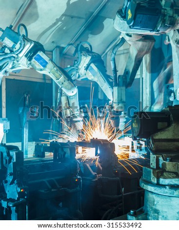 Team Robot welding  movement Industrial automotive part in factory