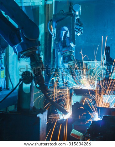 Team Robot welding  movement Industrial automotive part in factory