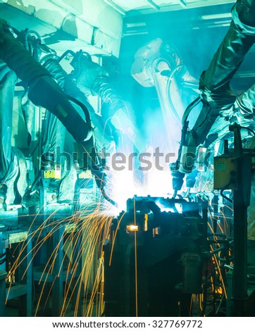 Team welding Robot movement Industrial automotive part in factory