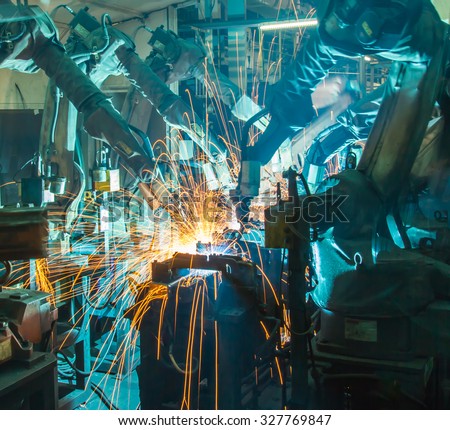 Team welding Robot movement Industrial automotive part in factory