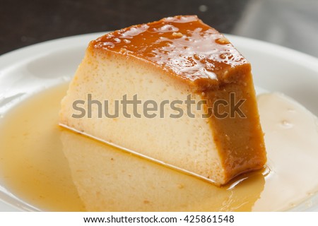 Slice of Milk Pudding over a wooden table