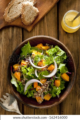 Overhead shot of quinoa salad with butternut squash and oil and vinegar dressing.