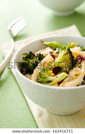 Closeup of pasta primavera with roasted broccoli and sun dried tomatoes.