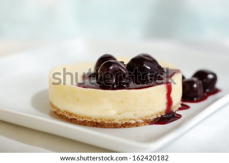 Mini cheesecake with dark cherries.