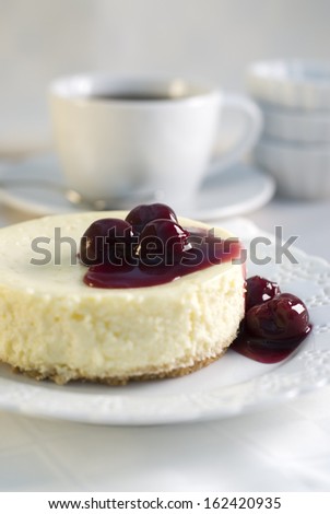 Mini cheesecake dessert with dark sweet cherries.
