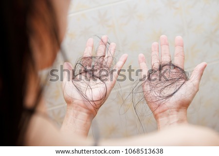 Hair falling out in two hands after rinse off shampoo.
