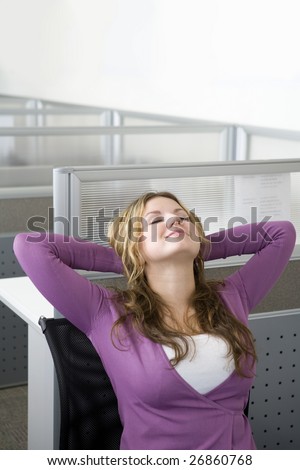 Businesswoman relaxing in office cubicle
