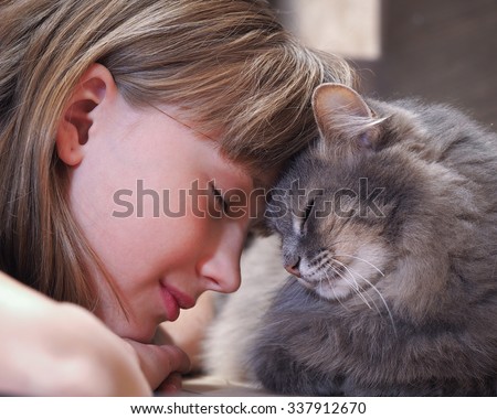 Cat and girl nose to nose. Tenderness, love, friendship. Sweet and loving picture of friendship and child cat
