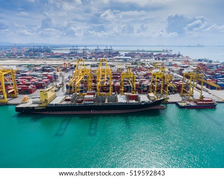 container,container ship in import export and business logistic.By crane , Trade Port , Shipping.Tugboat assisting cargo to harbor.Aerial view.