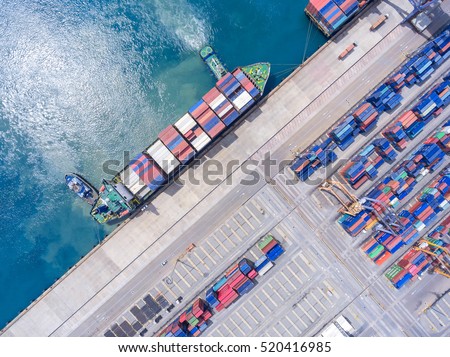 container ship in import export and business logistic.By crane , Trade Port , Shipping.Tugboat assisting cargo to harbor.Aerial view.Water transport.International.Shell Marine.