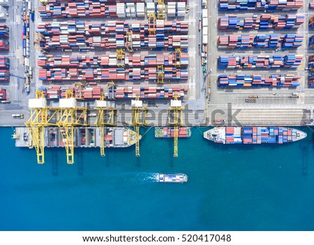 container ship in import export and business logistic.By crane , Trade Port , Shipping.Tugboat assisting cargo to harbor.Aerial view.Water transport.International.Shell Marine.
