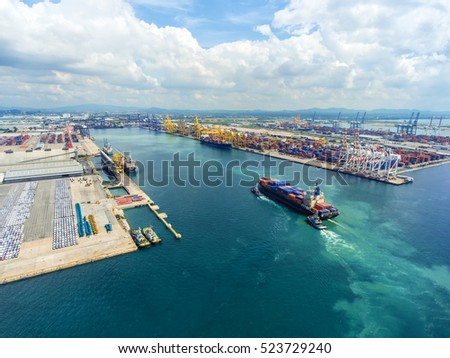 container,container ship in import export and business logistic.By crane , Trade Port , Shipping.Tugboat assisting cargo to harbor.Aerial view.Water transport.International.Shell Marine.Top view.