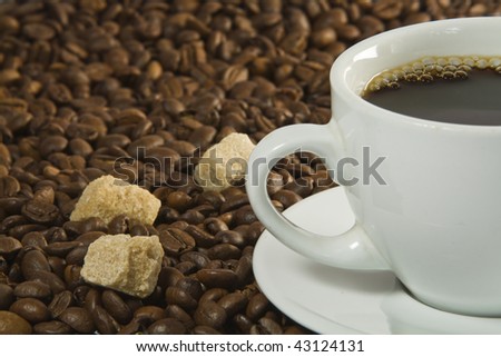 Coffee Cup and sugar with Coffee Beans background