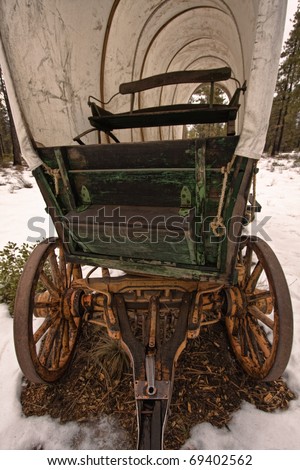 Old covered wagon in the snow; part of western series in portfolio