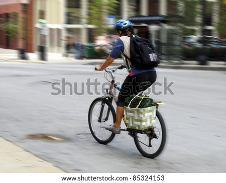 Market day on bicycle; intentional blur by panning.