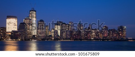 The New York City skyline at twilight w the Freedom tower