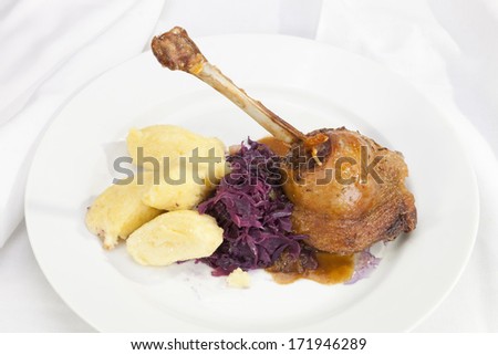 Baked duck leg with red cabbage and  potato dumplings