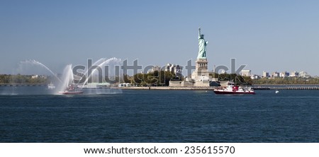 NEW YORK, USA, SEPT 27: The New York City Fire Department Boat practices maneuvers  in the Hudson River of New York City and Statue of Liberty on September 27, 2014