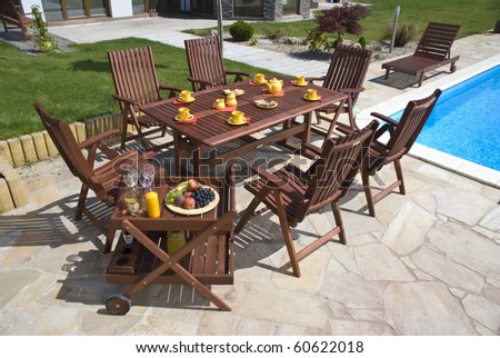 The Garden furniture by the pool w place setting