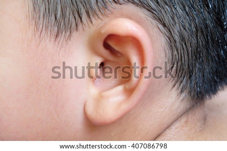 ear wall at entrance to inner ear with water drops of a asian boy with black hair