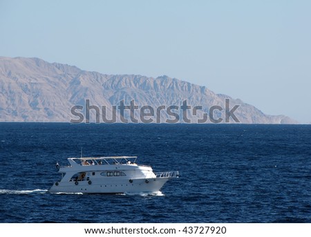 Pleasure boat on the background of the island of Tiran, Red Sea, Egypt
