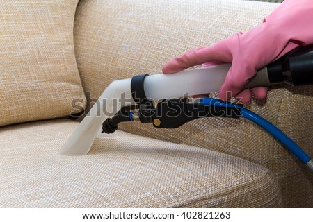 Sofa or armchair chemical cleaning with professionally extraction method. Upholstered furniture. Early spring cleaning or regular clean up.