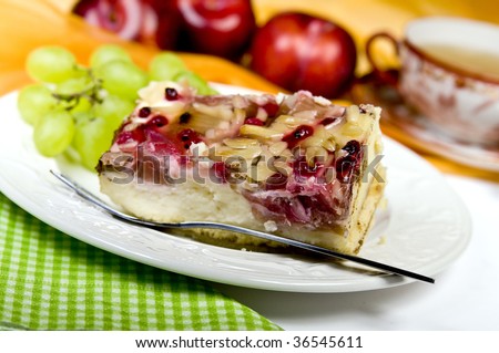 Rhubarb cake on a plate with Fruits and a Cup of Tea