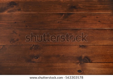 Top view on wooden planks of dinner table polished and tied each to other solidly, rich wooden textured background