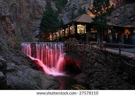 Waterfall and lodge at Seven Falls Park in Colorado Springs. At night, these falls are illuminated with several different colors in series.