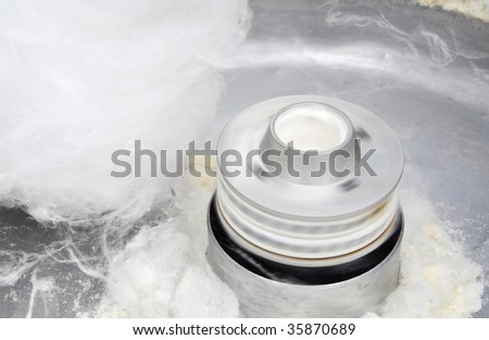 white spun sugar in a candy machine
