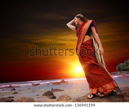 Woman on the Indian ocean in red sari