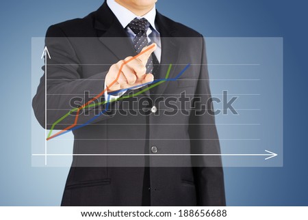 the Image of male hand pointing at business graphics