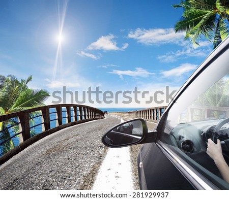 Asphalt road along a blue tropical sea