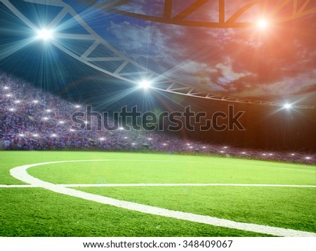 Soccer ball on green stadium, arena in night illuminated bright